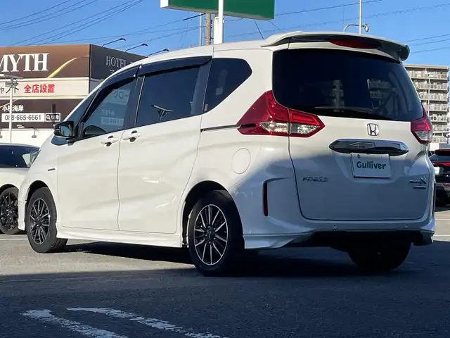 ホンダ フリード ハイブリット モデューロX ホンダセンシング 徳島県 2021(令3)年 3.4万km プラチナホワイトパール 純正9インチナビ/（Bluetooth/フルセグTV/CD/DVD/ラジオ/HDMI/USB）/バックカメラ/両側パワースライドドア/追従式クルーズコントロール/LEDヘッドライト/フォグライト/オートライト/純正15AW/純正フロアマット/ドアバイザー/電格ミラー/プッシュスタート/スマートキー/取扱説明書/保証書/記録簿