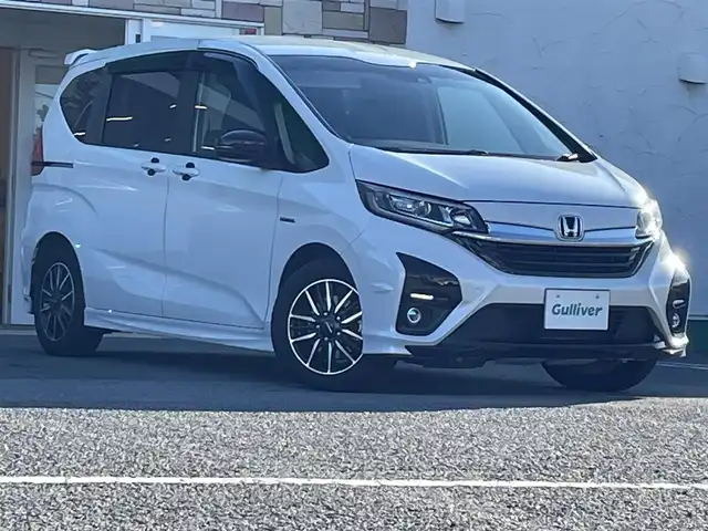 ホンダ フリード ハイブリット モデューロX ホンダセンシング 徳島県 2021(令3)年 3.4万km プラチナホワイトパール 純正9インチナビ/（Bluetooth/フルセグTV/CD/DVD/ラジオ/HDMI/USB）/バックカメラ/両側パワースライドドア/追従式クルーズコントロール/LEDヘッドライト/フォグライト/オートライト/純正15AW/純正フロアマット/ドアバイザー/電格ミラー/プッシュスタート/スマートキー/取扱説明書/保証書/記録簿