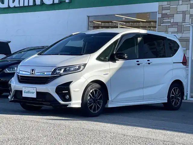 ホンダ フリード ハイブリット モデューロX ホンダセンシング 徳島県 2021(令3)年 3.4万km プラチナホワイトパール 純正9インチナビ/（Bluetooth/フルセグTV/CD/DVD/ラジオ/HDMI/USB）/バックカメラ/両側パワースライドドア/追従式クルーズコントロール/LEDヘッドライト/フォグライト/オートライト/純正15AW/純正フロアマット/ドアバイザー/電格ミラー/プッシュスタート/スマートキー/取扱説明書/保証書/記録簿