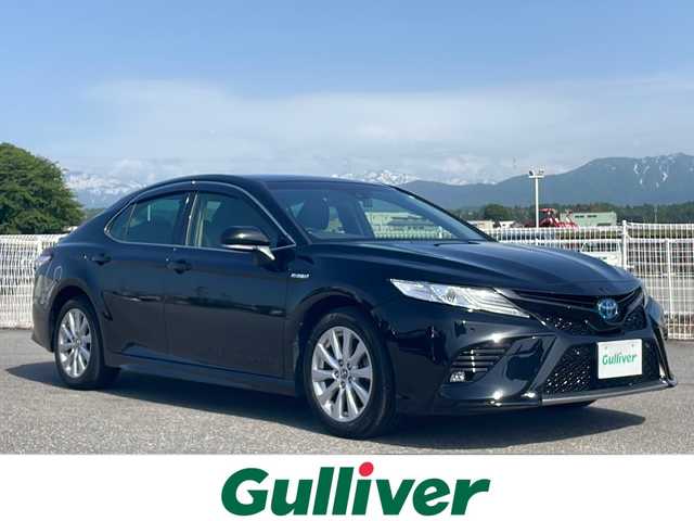 トヨタ カムリ WS 富山県 2019(令1)年 6.7万km アティチュードブラックマイカ 純正アルミホイール　/純正メモリナビ【フルセグＴＶ／ＤＶＤ／ＣＤ／Ｂｌｕｅｔｏｏｔｈ】/クルーズコントロール【追従走行有】　/アンチロックブレーキシステム　/横滑り防止装置　/コーナーセンサー【前後】/レーンキープアシスト/盗難防止装置/車外カメラ【バック】/オートライト/100V充電/電動リアゲート/パワーシート【D席】/エンジンスタートボタン/キセノンヘッドライト/エアバッグ【W＋サイド】/ハーフレザーシート/ETC/ドライブレコーダー【前方のみ】
