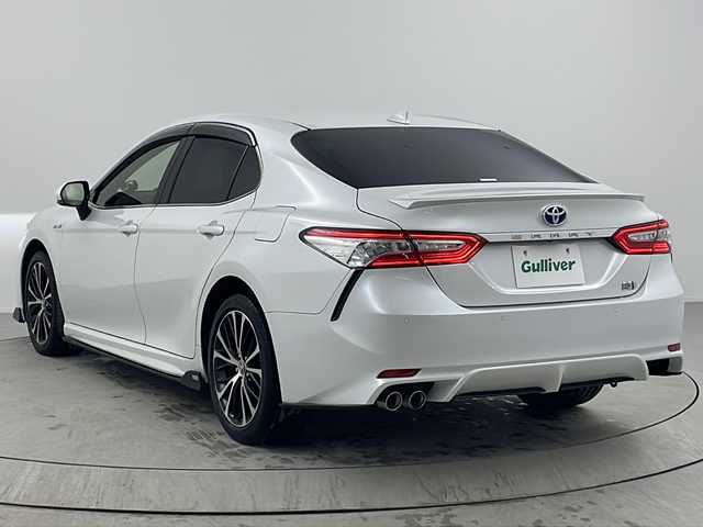 トヨタ カムリ WSレザーパッケージ 熊本県 2019(令1)年 6.1万km プラチナホワイトパールマイカ TOM’Sエアロ（前・横・後下）/レザーシート/ブラインドスポットモニター/純正8インチナビ/　「CD/DVD/フルセグTV/BT/USB」/純正ダブルツィーター/バックカメラ/追従型クルーズコントロール/オートハイビーム/LEDヘッドライト（AUTO機能付き）/ビルトインETC/前席シートヒータ/前席パワーシート/衝突軽減ブレーキシステム/車線逸脱防止システム/横滑り防止装置/純正ドライブレコーダー（前）/純正18インチアルミホイール/純正フロアマット/ステアリングヒーター/スマートキー/プッシュスタート/ヘッドアップディスプレイ/パドルシフト/バイザー/新車保証書/取扱説明書/スペアキー×１