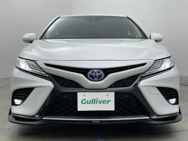 トヨタ カムリ WSレザーパッケージ 岡山県 2019(令1)年 6.1万km プラチナホワイトパールマイカ TOM’Sエアロ（前・横・後下）/レザーシート/ブラインドスポットモニター/純正8インチナビ/　「CD/DVD/フルセグTV/BT/USB」/純正ダブルツィーター/バックカメラ/追従型クルーズコントロール/オートハイビーム/LEDヘッドライト（AUTO機能付き）/ビルトインETC/前席シートヒータ/前席パワーシート/衝突軽減ブレーキシステム/車線逸脱防止システム/横滑り防止装置/純正ドライブレコーダー（前）/純正18インチアルミホイール/純正フロアマット/ステアリングヒーター/スマートキー/プッシュスタート/ヘッドアップディスプレイ/パドルシフト/バイザー