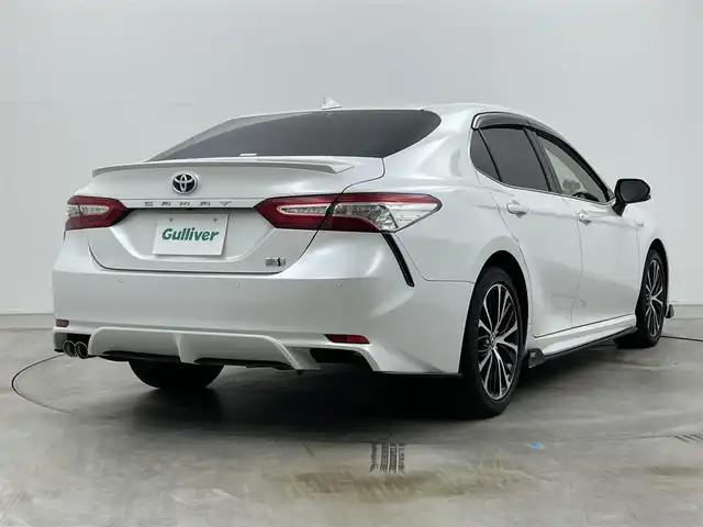 トヨタ カムリ WSレザーパッケージ 岡山県 2019(令1)年 6.1万km プラチナホワイトパールマイカ TOM’Sエアロ（前・横・後下）/レザーシート/ブラインドスポットモニター/純正8インチナビ/　「CD/DVD/フルセグTV/BT/USB」/純正ダブルツィーター/バックカメラ/追従型クルーズコントロール/オートハイビーム/LEDヘッドライト（AUTO機能付き）/ビルトインETC/前席シートヒータ/前席パワーシート/衝突軽減ブレーキシステム/車線逸脱防止システム/横滑り防止装置/純正ドライブレコーダー（前）/純正18インチアルミホイール/純正フロアマット/ステアリングヒーター/スマートキー/プッシュスタート/ヘッドアップディスプレイ/パドルシフト/バイザー