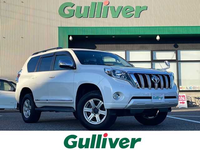 トヨタ ランドクルーザー プラド TX 島根県 2014(平26)年 6.5万km ホワイトパールクリスタルシャイン 社外7インチメモリナビゲーション(AVIC-VH0009)/フルセグ BT SD CD DVD/サンルーフ/ヒッチメンバー/ルーフレール/バックカメラ/ヘッドライトウォッシャー/革巻きステアリングウッドコンビ/LEDヘッドライト/AUTOライト/フォグライト/ETC/革調シートカバー/社外17インチアルミホイール