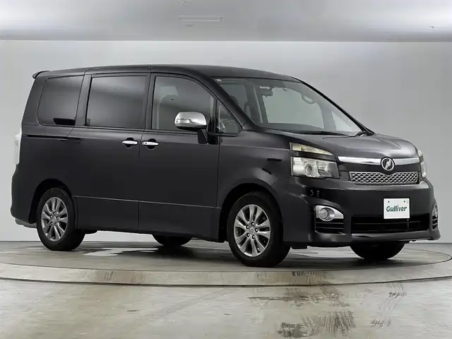 トヨタ ヴォクシー ZS 煌 愛知県 2011(平23)年 13.5万km ボルドーマイカメタリック メモリナビ/（AM/FM/CD/DVD/TV）/バックカメラ/フリップダウンモニター/ワンセグテレビ/パドルシフト/オートライト/ドアバイザー/プッシュスタート/スマートキー/純正フロアマット/レザーシートカバー付