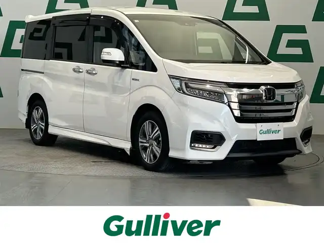 ホンダ ステップワゴン スパーダ ハイブリッド G ホンダセンシング 鹿児島県 2018(平30)年 5.9万km プラチナホワイトパール 禁煙　/純正９インチナビ　/純正フリップダウンモニター　/バックカメラ　/両側パワースライドドア　/ホンダセンシング　/追従型クルーズコントロール　/前方ドライブレコーダー　/ビルトインＥＴＣ　/ＬＥＤヘッドライト/オートライト/フロアマット/オートブレーキホールド/革巻きステアリング/ステアリングリモコン