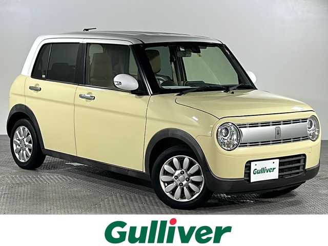 スズキ ラパン X 沖縄県 2016(平28)年 8.5万km シフォンアイボリーメタリック 禁煙車　/県外仕入れ　/８インチ社外ナビ/【ＣＤ／ＤＶＤ／フルセグＴＶ／ＢＴ】　/ＥＴＣ　/Ｄ席シートヒーター/横滑り防止装置　/衝突被害軽減システム/１４インチ純正アルミ　/オートライト　　/スマートキー