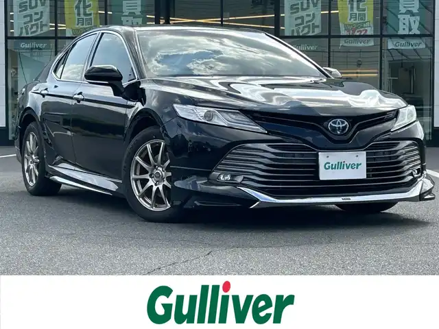 トヨタ カムリ G レザーパッケージ 岡山県 2018(平30)年 5.7万km アティチュードブラックマイカ 登録時走行距離56716km/モデリスタ/純正ナビ/フルセグTV(AM/FM/CD/DVD/Bluetooth)/バックカメラ/ビルトインETC2.0/ヘッドアップディスプレイ/トヨタセーフティセンス/・ブラインドスポットモニター/・レーダークルーズコントロール/・オートマチックハイビーム/・プリクラッシュセーフティ/・レーンディバーチャーアラート/横滑り防止装置/電子パーキング/オートブレーキホールド/D/N席パワーシート/D/N席シートヒーター/本革シート/純正フロアマット/17インチ社外AW