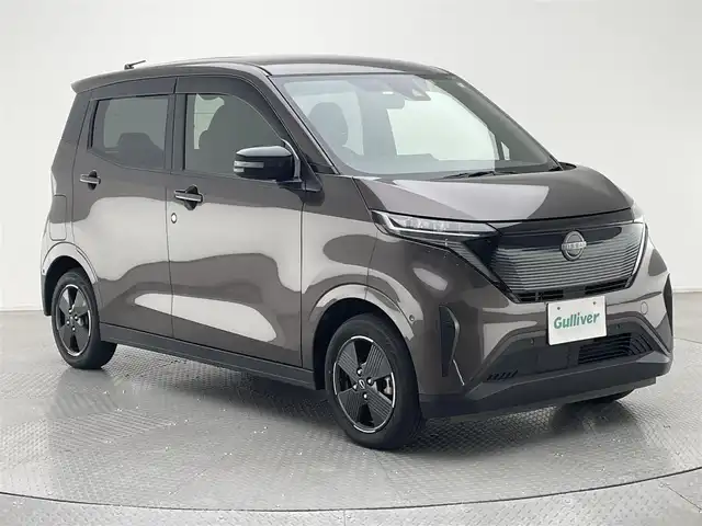 日産 サクラ X 兵庫県 2023(令5)年 3万km 茶 純正9インチディスプレイオーディオ/（BT、APPLECarPlay、Android　Aut）/バックカメラ/先行車発進お知らせ/ウィンカーミラー/オートライト/純正フロアマット/ドアバイザー/LEDヘッドライト/プッシュスタート/Eペダル/スマートキー/純正14インチAW
