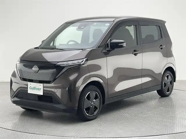 日産 サクラ X 兵庫県 2023(令5)年 3万km 茶 純正9インチディスプレイオーディオ/（BT、APPLECarPlay、Android　Aut）/バックカメラ/先行車発進お知らせ/ウィンカーミラー/オートライト/純正フロアマット/ドアバイザー/LEDヘッドライト/プッシュスタート/Eペダル/スマートキー/純正14インチAW