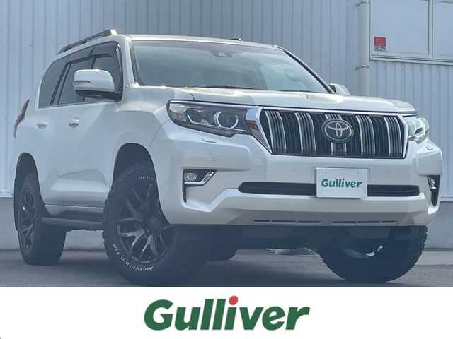 トヨタ ランドクルーザー プラド TX Lパッケージ 愛媛県 2018(平30)年 7.7万km ホワイトパールクリスタルシャイン 純正ナビ/AM/FM/CD/DVD/BT/フルセグTV/全周囲カメラ/サンルーフ/現状RAＹsアルミホイール/積込純正AW付スタッドレスタイヤ/BF Goodrich All-Terrain T/A/トヨタセーフティセンス/電動格納サードシート/D/N席パワーシート/D/N席シートヒーター/D/N席シートエアコン/ブラックルーフレール/ヘッドライトウォッシャー/フロントワイパーデアイサー/ブラインドスポットモニター/純正ドアバイザー/排気ガス浄化スイッチ/ステアリングスイッチ/電格ミラー/ベージュレザー