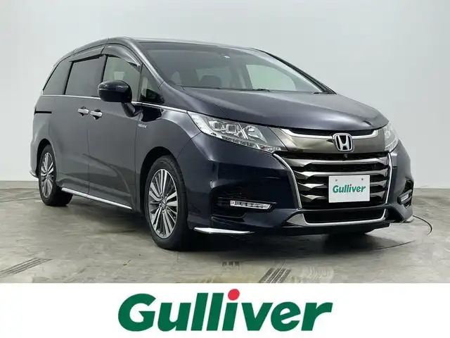 ホンダ オデッセイ ハイブリッド アブソルート・EXホンダセンジング 岡山県 2018(平30)年 2.4万km プレミアムヴィーナスブラックP ディーラーオプション/・Gathers9インチナビ VXM-187VFNi/HDMI/地デジTV/CD/DVD/BT/CarPlay/USB/ホンダセンシング /・アダプティブクルーズコントロール/・衝突軽減ブレーキ/・レーンキープアシスト/マルチビューカメラ/パーキングアシスト /ブラインドスポットインフォメーション/LEDヘッドランプ/パーキングセンサー/純正17インチアルミホイール/両側パワースライドドア /前席シートヒーター/前席パワーシート /合皮ファブリックコンビシート/オットマン