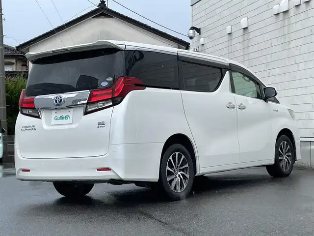 トヨタ アルファードハイブリット G 山形県 2016(平28)年 7.6万km ホワイトパールクリスタルシャイン 禁煙車/4WD/純正10インチナビ//フルセグ/CD/DVD/SD/AM//FM/iPod/BT/AUX/純正フリップダウンモニター/ハーフレザーシート/ETC/クルーズコントロール/プリクラッシュセーフティー/ステアリングスイッチ/オートLEDヘッドライト/オートワイパー/フォグランプ/プッシュスタート