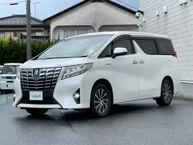 トヨタ アルファードハイブリット G 山形県 2016(平28)年 7.6万km ホワイトパールクリスタルシャイン 禁煙車/4WD/純正10インチナビ//フルセグ/CD/DVD/SD/AM//FM/iPod/BT/AUX/純正フリップダウンモニター/ハーフレザーシート/ETC/クルーズコントロール/プリクラッシュセーフティー/ステアリングスイッチ/オートLEDヘッドライト/オートワイパー/フォグランプ/プッシュスタート