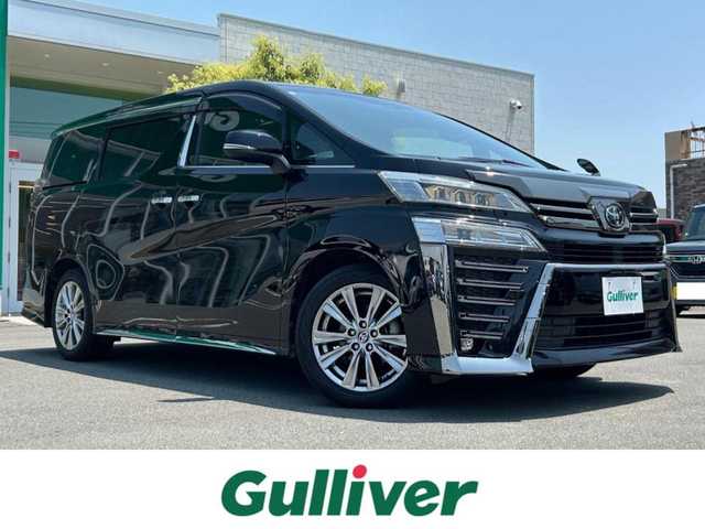 トヨタ ヴェルファイア ゴールデンアイズⅡ 静岡県 2021(令3)年 3.9万km ブラック エンジンスタートボタン/取扱説明書/パワーステアリング/パワーウィンドウ/100V充電/スマートキー/スペアキー１本/Wオートエアコン/クルーズコントロール/フリップダウンモニター/USB入力端子/純正ETC2.0/バックカメラ/純正９インチナビ（CD/DVD/BT）/三列シート/サンルーフ/オットマン/電動リアゲート/ドライブレコーダー前後/ウォークスルー/フロアマット/ハーフレザー/両側パワースライドドア/純正18インチアルミホイール/ABS/横滑り防止装置/コーナーセンサー前後/レーンキープアシスト/オートライト/オートマチックハイビーム/三眼LEDヘッドライト/W+サイドエアバック/衝突軽減システム/カーテンエアバック/BSM(ブラインドスポットモニター)