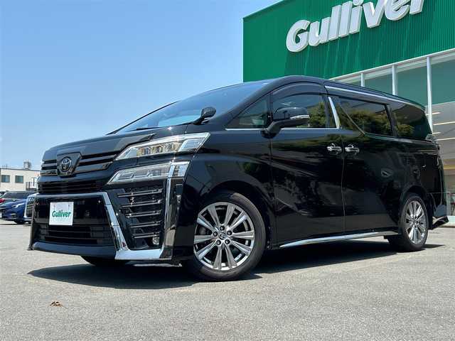 トヨタ ヴェルファイア ゴールデンアイズⅡ 静岡県 2021(令3)年 3.9万km ブラック エンジンスタートボタン/取扱説明書/パワーステアリング/パワーウィンドウ/100V充電/スマートキー/スペアキー１本/Wオートエアコン/クルーズコントロール/フリップダウンモニター/USB入力端子/純正ETC2.0/バックカメラ/純正９インチナビ（CD/DVD/BT）/三列シート/サンルーフ/オットマン/電動リアゲート/ドライブレコーダー前後/ウォークスルー/フロアマット/ハーフレザー/両側パワースライドドア/純正18インチアルミホイール/ABS/横滑り防止装置/コーナーセンサー前後/レーンキープアシスト/オートライト/オートマチックハイビーム/三眼LEDヘッドライト/W+サイドエアバック/衝突軽減システム/カーテンエアバック/BSM(ブラインドスポットモニター)