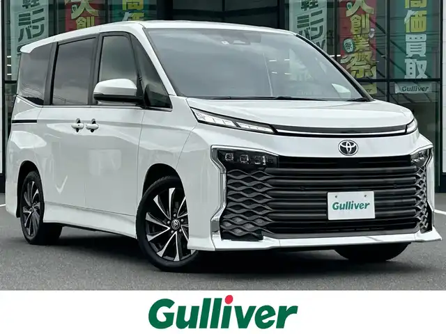 トヨタ ヴォクシー S－Z 岡山県 2022(令4)年 7.6万km ホワイトパールクリスタルシャイン 登録時走行距離75914km/快適利便パッケージ/トヨタセーフティセンス/純正10.5型ディスプレイオーディオナビTV/（T-CONNECT/Bluetooth/CD/DVD/FMAM/フルセグTV）/純正14型リアフリップダウンモニター/純正バックカメラ/純正ビルトイン2.0ETC/純正3眼LEDオートライト/純正LEDフォグ/純正17インチアルミ/両側電動スライドドア/プリクラッシュセーフティ/オートマチックハイビーム/レーンディパーチャーアラート/アダプティブクルーズコントロール/電子パーキング/オートホールド/クリアランスソナー/ウインカードアミラー/Wオートエアコン/前席シートヒーター/スマートキー/プッシュエンジンスタート/新車時保証書