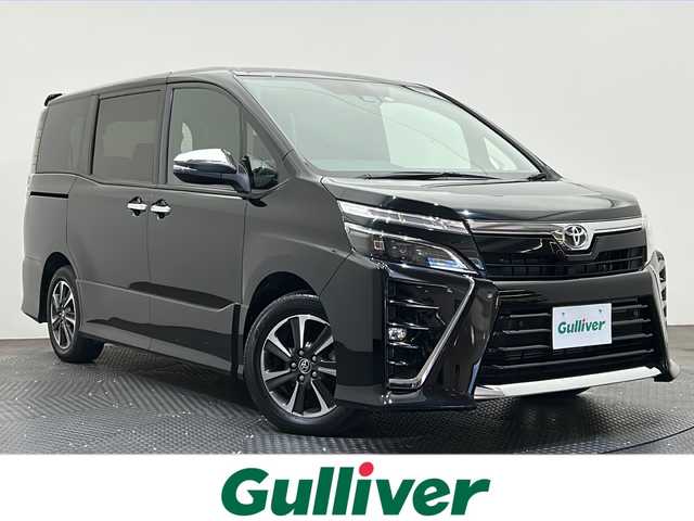トヨタ ヴォクシー ZS 煌Ⅲ 愛媛県 2021(令3)年 2.6万km ブラック ・１０型ナビ（フルセグＴＶ・ＢＴ・ＣＤ・ＤＶＤ・ＳＤ・ＦＭ・ＡＭ）/・バックカメラ　/・１２．１型後席モニター　/・クルーズコントロール　/・ＥＴＣ　/・衝突軽減ブレーキ　/・オートマチックハイビーム　/・レーンキープアシスト/・両側パワースライドドア/・USB充電
