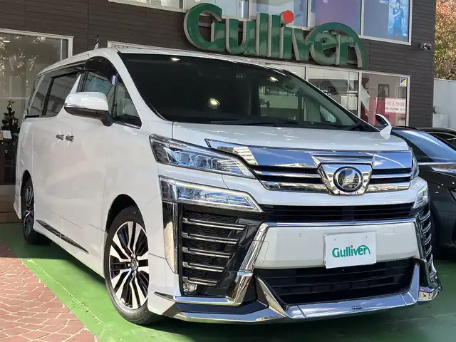 トヨタ ヴェルファイア Z Gエディション 神奈川県 2018(平30)年 7.7万km ホワイトパールクリスタルシャイン ワンオーナー/新車保証書/取扱説明書/レザーシート/サンルーフ/モデリスタエアロ/3眼LEDヘッドライト/トヨタセーフティセンス/・レーンレーシングアシスト/・クリアランスソナー/・プリクラッシュセーフティ/・ロードサインアシスト/・レーダークルーズコントロール（全車速追従機能付き）/・オートマチックハイビーム/純正ナビ・フルセグTV/CD・DVDビデオ・Bluetooth/HDMI・USB・SD/バックカメラ/デジタルインナーミラー/純正フリップダウンモニター/ビルトインETC2.0/前席パワーシート/前席快適温熱シート/助手席・後席電動オットマン/後席エグゼクティブパワーシート/両側パワースライドドア/パワーバックドア/ステアリングスイッチ/サンシェード/純正18インチアルミホイール/ドアバイザー/フロアーマット