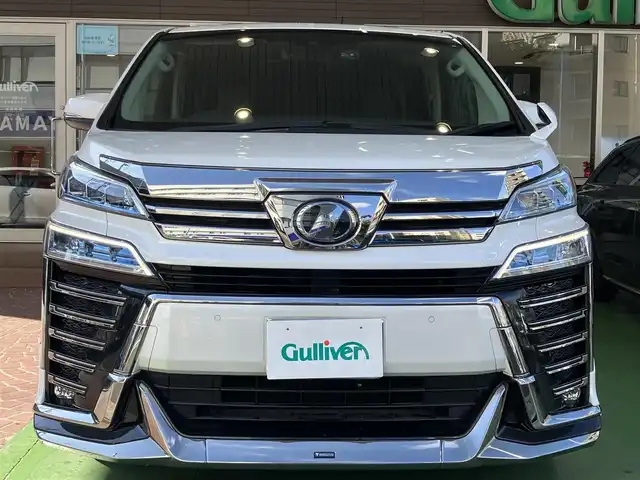 トヨタ ヴェルファイア Z Gエディション 神奈川県 2018(平30)年 7.7万km ホワイトパールクリスタルシャイン ワンオーナー/新車保証書/取扱説明書/レザーシート/サンルーフ/モデリスタエアロ/3眼LEDヘッドライト/トヨタセーフティセンス/・レーンレーシングアシスト/・クリアランスソナー/・プリクラッシュセーフティ/・ロードサインアシスト/・レーダークルーズコントロール（全車速追従機能付き）/・オートマチックハイビーム/純正ナビ・フルセグTV/CD・DVDビデオ・Bluetooth/HDMI・USB・SD/バックカメラ/デジタルインナーミラー/純正フリップダウンモニター/ビルトインETC2.0/前席パワーシート/前席快適温熱シート/助手席・後席電動オットマン/後席エグゼクティブパワーシート/両側パワースライドドア/パワーバックドア/ステアリングスイッチ/サンシェード/純正18インチアルミホイール/ドアバイザー/フロアーマット
