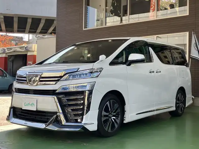 トヨタ ヴェルファイア Z Gエディション 神奈川県 2018(平30)年 7.7万km ホワイトパールクリスタルシャイン ワンオーナー/新車保証書/取扱説明書/レザーシート/サンルーフ/モデリスタエアロ/3眼LEDヘッドライト/トヨタセーフティセンス/・レーンレーシングアシスト/・クリアランスソナー/・プリクラッシュセーフティ/・ロードサインアシスト/・レーダークルーズコントロール（全車速追従機能付き）/・オートマチックハイビーム/純正ナビ・フルセグTV/CD・DVDビデオ・Bluetooth/HDMI・USB・SD/バックカメラ/デジタルインナーミラー/純正フリップダウンモニター/ビルトインETC2.0/前席パワーシート/前席快適温熱シート/助手席・後席電動オットマン/後席エグゼクティブパワーシート/両側パワースライドドア/パワーバックドア/ステアリングスイッチ/サンシェード/純正18インチアルミホイール/ドアバイザー/フロアーマット