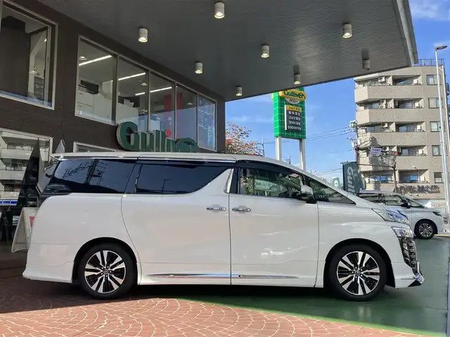 トヨタ ヴェルファイア Z Gエディション 神奈川県 2018(平30)年 7.7万km ホワイトパールクリスタルシャイン ワンオーナー/新車保証書/取扱説明書/レザーシート/サンルーフ/モデリスタエアロ/3眼LEDヘッドライト/トヨタセーフティセンス/・レーンレーシングアシスト/・クリアランスソナー/・プリクラッシュセーフティ/・ロードサインアシスト/・レーダークルーズコントロール（全車速追従機能付き）/・オートマチックハイビーム/純正ナビ・フルセグTV/CD・DVDビデオ・Bluetooth/HDMI・USB・SD/バックカメラ/デジタルインナーミラー/純正フリップダウンモニター/ビルトインETC2.0/前席パワーシート/前席快適温熱シート/助手席・後席電動オットマン/後席エグゼクティブパワーシート/両側パワースライドドア/パワーバックドア/ステアリングスイッチ/サンシェード/純正18インチアルミホイール/ドアバイザー/フロアーマット