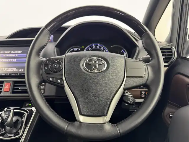 トヨタ エスクァイア ハイブリッド Gi 愛知県 2015(平27)年 7.4万km スパークリングブラックパールクリスタルシャイン TRDフロントエアロ/純正8インチSDナビ　NSZT-Y64/フルセグTV/Bluetooth/CD/DVD　/純正フリップダウンモニター/バックカメラ　/ビルトインETC　/両側パワースライドドア/シートヒーター　（D・N）/クルーズコントロール　/置くだけ充電/ステアリングリモコン　/革巻きステアリング　/黒革調シート　/ウッドコンビハンドル/フォグランプ　