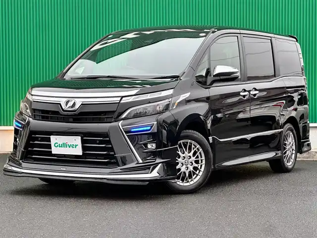 トヨタ ヴォクシー ハイブリッド ZS 煌Ⅲ 宮城県 2020(令2)年 5.8万km ブラック モデリスタエアロ（F/S/R）/マフラーカッター/セーフティセンス/・プリクラッシュセーフティ/・レーンディパーチャーアラート/・オートマチックハイビーム/・先行車発進告知機能/インテリジェントクリアランスソナー/純正10インチナビ（NSZN-Z68T）/・CD/DVD/・Bluetooth/・フルセグTV/・SD音楽録音機能/バックカメラ/ビルトインETC/ドライブレコーダー/両側パワースライドドア/ハーフレザーシート/シートヒーター/革巻きステアリング/クルーズコントロール/ステアリングスイッチ/LEDヘッドライト/フォグランプ/オートライト/スマートキー＆プッシュスタート/電動格納ミラー/純正16インチAW/フロアマット/Wエアバッグ