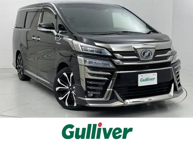トヨタ ヴェルファイア ハイブリット エグゼクティブ ラウンジ 茨城県 2019(令1)年 2万km バーニングブラッククリスタルシャインガラスフレーク 純正ナビ/フルセグ視聴可/DVD再生可/Bluetooth接続/後席モニター/クルコン（追従有）/USB入力端子/全方位カメラ/ETC2.0/ドラレコ/パワーシート（D＋N席）/シートヒーター（D＋N席）/エアシート（D＋N席）/オットマン/電動リアゲート/モデリスタアエロ/モデリスタAW/JBL/ステアリングヒーター/デジタルインナーミラー