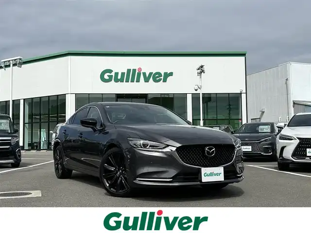 マツダ マツダ６セダン XD ブラックトーンエディション 愛媛県 2022(令4)年 2.1万km マシーングレープレミアムM 登録時走行距離：20955km/BOSEスピーカー/パドルシフト/革シート/メーカーOP純正ナビ/AM/FM/フルセグTV/DVD/CD/前後ドラレコ/ETC2.0/全周囲カメラ/追従クルコン/レーンキープアシスト/パーキングアシスト/衝突軽減システム/横滑り防止装置/電動リアゲート/LEDヘッドライト/オートライト/エンジンスタートボタン/スマートキー/純正アルミホイール/純正フロアマット