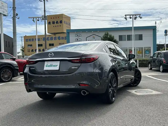 マツダ マツダ６セダン XD ブラックトーンエディション 愛媛県 2022(令4)年 2.1万km マシーングレープレミアムM 登録時走行距離：20955km/BOSEスピーカー/パドルシフト/革シート/メーカーOP純正ナビ/AM/FM/フルセグTV/DVD/CD/前後ドラレコ/ETC2.0/全周囲カメラ/追従クルコン/レーンキープアシスト/パーキングアシスト/衝突軽減システム/横滑り防止装置/電動リアゲート/LEDヘッドライト/オートライト/エンジンスタートボタン/スマートキー/純正アルミホイール/純正フロアマット