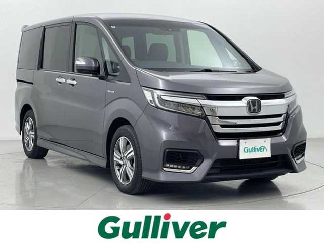ホンダ ステップワゴン スパーダ ハイブリッド G EX ホンダセンシング 熊本県 2018(平30)年 6.7万km モダンスティールM 純正９インチナビVXM-187VFNi（ＣＤ・ＤＶＤ・フルセグ・ＢＴ・ＳＤ・ＵＳＢ）/バックカメラ　/社外前方ドライブレコーダー　/ビルトインＥＴＣ　/両側パワースライドドア　/前席シートヒーター　/ホンダセンシング/・衝突軽減ブレーキ/・アダブティブクルーズコントロール/・オートハイビーム/・先行車発進お知らせ機能/・路外逸脱制御/・レーンキープアシスト/・標識認識機能/横滑り防止/電動パーキング/ブレーキホールド/ハーフレザーシート/純正フロアマット/純正16インチAW/オートライト/LEDヘッドライト/フォグランプ/スマートキー/プッシュスタート/保証書