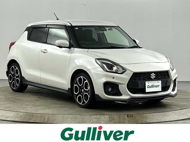 スズキ スイフト スポーツ セーフティPKG 愛知県 2018(平30)年 4.5万km ピュアホワイトP 純正８インチナビ（AM/FM/地デジ/BT/CD/DVD）/全方位カメラ/D席シートヒーター/衝突軽減ブレーキ/レーンキープアシスト/横滑り防止機能/クリアランスソナー/レーダークルーズコントロール/パドルシフト/ビルトインETC/純正17インチアルミホイール/LEDヘッドライト/フォグランプ/前後コーナーセンサー/ドアバイザー/純正ドライブレコーダー/スマートキー/プッシュスタート/スペアキー/電格ミラー