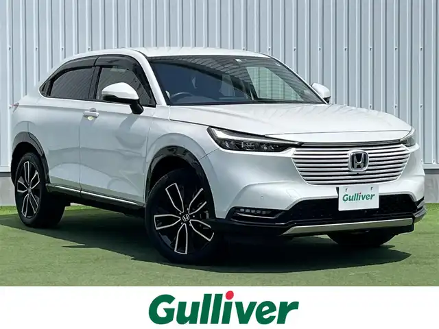 ホンダ ヴェゼル ハイブリッド e:HEV Z 香川県 2022(令4)年 2.1万km プラチナホワイトパール Honda SENSING/純正9インチワイドディスプレイナビ/　AM FM Bluetooth AppleCarPlay AndroidAuto/フルセグTV/ビルトインETC2.0/レーダークルーズコントロール/全方位カメラ/ドライブレコーダー/置くだけ充電/BSM/LEDオートヘッドライト/シーケンシャルターンランプ/デジタルインナーミラー/ハーフレザーシート/シートヒーター(前席)/パワーバックドア/純正18インチアルミホイール/スマートキー2本/ワンオーナー