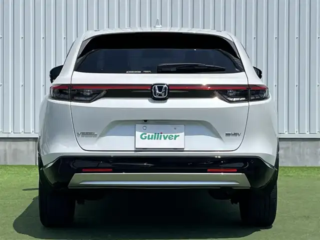 ホンダ ヴェゼル ハイブリッド e:HEV Z 香川県 2022(令4)年 2.1万km プラチナホワイトパール Honda SENSING/純正9インチワイドディスプレイナビ/　AM FM Bluetooth AppleCarPlay AndroidAuto/フルセグTV/ビルトインETC2.0/レーダークルーズコントロール/全方位カメラ/ドライブレコーダー/置くだけ充電/BSM/LEDオートヘッドライト/シーケンシャルターンランプ/デジタルインナーミラー/ハーフレザーシート/シートヒーター(前席)/パワーバックドア/純正18インチアルミホイール/スマートキー2本/ワンオーナー