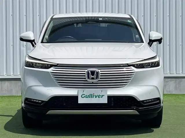 ホンダ ヴェゼル ハイブリッド e:HEV Z 香川県 2022(令4)年 2.1万km プラチナホワイトパール Honda SENSING/純正9インチワイドディスプレイナビ/　AM FM Bluetooth AppleCarPlay AndroidAuto/フルセグTV/ビルトインETC2.0/レーダークルーズコントロール/全方位カメラ/ドライブレコーダー/置くだけ充電/BSM/LEDオートヘッドライト/シーケンシャルターンランプ/デジタルインナーミラー/ハーフレザーシート/シートヒーター(前席)/パワーバックドア/純正18インチアルミホイール/スマートキー2本/ワンオーナー