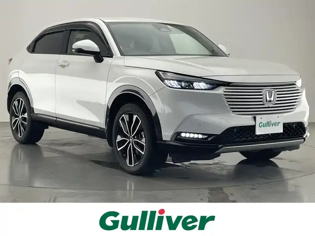 ホンダ ヴェゼル ハイブリッド e:HEV Z 愛知県 2022(令4)年 2.1万km プラチナホワイトパール Honda SENSING/純正9インチワイドディスプレイナビ/　AM FM Bluetooth AppleCarPlay AndroidAuto/フルセグTV/ビルトインETC2.0/レーダークルーズコントロール/全方位カメラ/ドライブレコーダー/置くだけ充電/BSM/LEDオートヘッドライト/シーケンシャルターンランプ/デジタルインナーミラー/ハーフレザーシート/シートヒーター(前席)/パワーバックドア/純正18インチアルミホイール/スマートキー2本/ワンオーナー
