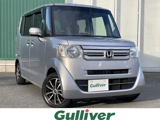 ホンダ Ｎ ＢＯＸ G ターボ Lパッケージ 福岡県 2015(平27)年 5.1万km カトラリーシルバーM Gathers7型ナビ/（BT/フルセグ/DISC/AM/FM/SD/iPod)/Bカメラ/片側パワースライドドア/クルーズコントロール/ベンチシート/チップアップシート/アルミホイール/パドルシフト/シートカバー/横滑り防止装置/盗難防止装置/スマートキー/ETC