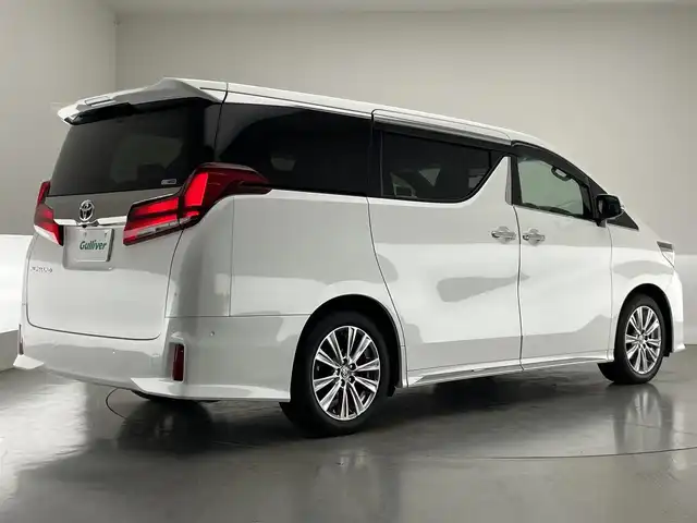トヨタ アルファード S タイプゴールドⅡ 愛知県 2021(令3)年 1.8万km ホワイトパールクリスタルシャイン メーカーナビ　ＪＢＬ　Ｗムーンルーフ　パーキングアシスト　リアエンターテイメントシステム　デジタルインナーミラー　全方位カメラ　ＤＶＤデッキ　ＡＣ１００Ｖ　三眼ＬＥＤ　衝突軽減　追従クルコン　ＢＳＭ　セーフティセンス　パワーバックドア　前後ドラレコ　オットマン　ハーフレザー　電動パーキング