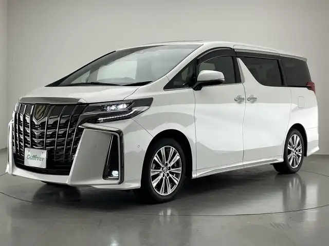 トヨタ アルファード S タイプゴールドⅡ 愛知県 2021(令3)年 1.8万km ホワイトパールクリスタルシャイン メーカーナビ　ＪＢＬ　Ｗムーンルーフ　パーキングアシスト　リアエンターテイメントシステム　デジタルインナーミラー　全方位カメラ　ＤＶＤデッキ　ＡＣ１００Ｖ　三眼ＬＥＤ　衝突軽減　追従クルコン　ＢＳＭ　セーフティセンス　パワーバックドア　前後ドラレコ　オットマン　ハーフレザー　電動パーキング
