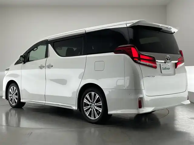 トヨタ アルファード S タイプゴールドⅡ 愛知県 2021(令3)年 1.8万km ホワイトパールクリスタルシャイン メーカーナビ　ＪＢＬ　Ｗムーンルーフ　パーキングアシスト　リアエンターテイメントシステム　デジタルインナーミラー　全方位カメラ　ＤＶＤデッキ　ＡＣ１００Ｖ　三眼ＬＥＤ　衝突軽減　追従クルコン　ＢＳＭ　セーフティセンス　パワーバックドア　前後ドラレコ　オットマン　ハーフレザー　電動パーキング