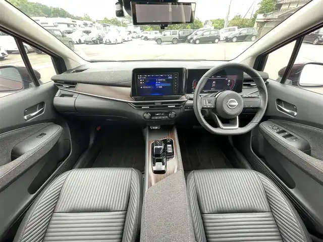 日産 オーラ G レザーエディション 愛媛県 2023(令5)年 0.7万km バーガンディー 純正9型ナビ/AM/FM/BT/フルセグTV/全周囲カメラ　/ブラインドスポットモニター　/インテリジェントルームミラー　/ドライブレコーダー　/ステアリングリモコン　/LEDヘッドライト　/前後コーナーセンサー　/電動パーキングブレーキ　/ETC/レザーシート/シガーソケット/ISOFIX/SPORT/ECO/NORMAL/EVモード/現状サマー(純正AW)(205/50/R17)/BRIDGESTONE TURANZA T005A