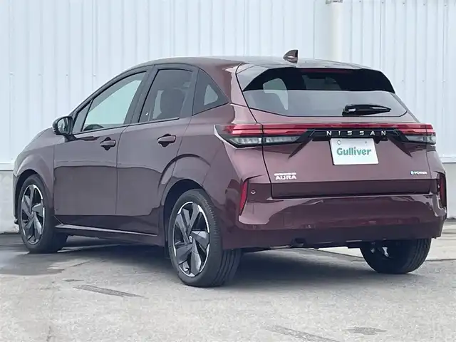日産 オーラ G レザーエディション 愛媛県 2023(令5)年 0.7万km バーガンディー 純正9型ナビ/AM/FM/BT/フルセグTV/全周囲カメラ　/ブラインドスポットモニター　/インテリジェントルームミラー　/ドライブレコーダー　/ステアリングリモコン　/LEDヘッドライト　/前後コーナーセンサー　/電動パーキングブレーキ　/ETC/レザーシート/シガーソケット/ISOFIX/SPORT/ECO/NORMAL/EVモード/現状サマー(純正AW)(205/50/R17)/BRIDGESTONE TURANZA T005A