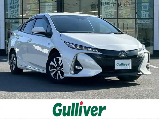 トヨタ プリウス ＰＨＶ S セーフティプラス 岡山県 2018(平30)年 8.8万km ホワイトパールクリスタルシャイン 登録時走行距離87926km/純正9インチナビ/フルセグTV(AM/FM/CD/DVD/Bluetooth)/バックカメラ/ドライブレコーダー/ビルトインETC/トヨタセーフティセンス/・プリクラッシュセーフティ/・レーダークルーズコントロール/・アドバンストパーク/・オートマチックハイビーム/・レーントレーシングアシスト/D/N席シートヒーター/ステアリングヒーター/USB/HDMI端子/純正フロアマット/15インチ純正AW/プッシュスタート/スマートキー