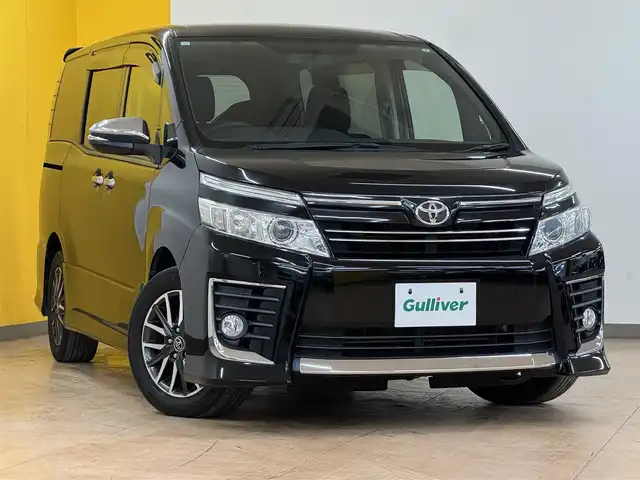 トヨタ ヴォクシー ZS 煌 群馬県 2015(平27)年 8.5万km ブラック 安全装備/・オートライト/・横滑り防止/社外10インチデカナビ/・AM/FM/Bluetooth/・CD/DVD/フルセグTV/バックカメラ/両側電動スライドドア/LEDヘッドライト/フォグランプ/ETC/純正ドアバイザー/純正16インチアルミホイール/スマートキー/プッシュスタート