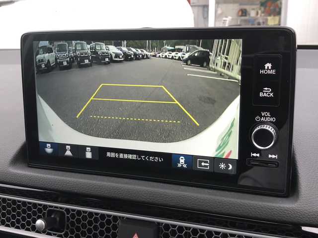 ホンダ シビック e:HEV EX 愛媛県 2024(令6)年 0.5万km プラチナホワイトパール ワンオーナー/純正ディスプレイオーディオ/・グーグルマップ連動/・Bluetooth/フルセグTV/USB/バックカメラ/BOSEサウンドシステム/サンルーフ/前後ドライブレコーダー/ハーフレザーシート/・D/Nパワーシート/・D/Nシートヒーター /ETC2.0/パドルシフト/置くだけ充電/テールゲートスポイラー/フロントグリル/ロアグリルガーニッシュ/・NH731P色分け/ホンダセンシング /●衝突軽減ブレーキ（CMBS）/●先行車発進お知らせ機能/●歩行者事故低減ステアリング/●路外逸脱抑制機能/●標識認識機能/●アダプティブクルーズコントロール/●車線維持支援システム（LKAS）/●トラフィックジャムアシスト（渋滞運転支援機能）/●ブラインドスポットインフォメーション/●誤発進抑制機能/●後方誤発進抑制機能/●近距離衝突軽減ブレーキ/●急アクセル抑制機能/●パーキングセンサーシステム/●後退出庫サポート/●オートハイビーム/●アダプティブドライビングビーム/トラフィックジャムアシスト（渋滞運転支援機能）/取扱説明書/保証書/スペアキー