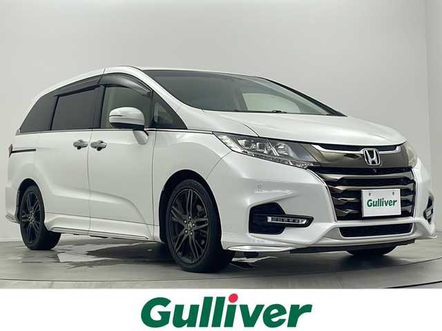 ホンダ オデッセイ アブソルート・EXホンダセンジング 大阪府 2018(平30)年 5.9万km プラチナホワイトパール 純正9インチナビ/(フルセグTV/Bluetooth/CD/DVD/HDMI)/純正11.6インチフリップダウンモニター/全方位カメラ/ブラインドスポットモニター/ホンダセンシング/・衝突軽減ブレーキ/・誤発進抑制装置/・路外逸脱抑制機能/・アダクティブクルーズコントロール/両側パワースライドドア/ハーフレザーシート/前席シートヒーター/後席オットマン/後席サンシェード/保証書/取扱説明書/点検記録簿