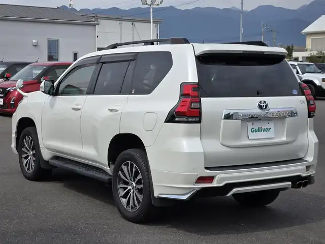 トヨタ ランドクルーザー プラド TX Lパッケージ 鹿児島県 2019(平31)年 6.7万km ホワイトパールクリスタルシャイン ムーンルーフ　/モデリスタエアロ（リア／フロント）　/ルーフレール　/ＡＬＰＩＮＥナビ　/Ｂｌｕｅｔｏｏｔｈオーディオ　/バックカメラ　/Ｄ＋Ｎ席シートヒーター　/Ｄ＋Ｎ席シートベンチレーション/D+N席パワーシート　/ビルトインＥＴＣ/前方ドライブレコーダー/前後コーナーセンサー/レーダークルーズコントロール/純正アルミホイール(19インチ)/横滑り防止装置/レーンキープアシスト/プッシュスタート/スマートキー/エアバッグ(W+サイド)/カーテンエアバッグ