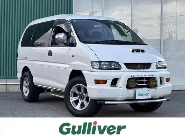 三菱 デリカ スペースギア XR 福岡県 1997(平9)年 8.1万km ソフィアホワイト コーナーセンサー（前後）/片側パワースライド/レザーシート/ベンチシート/3列シート/純正AW/純正フロアマット/ワンセグTV/バックカメラ/ETC/CD・CDチェンジャー/後席モニター/AAC/リモコンキー/ターボ