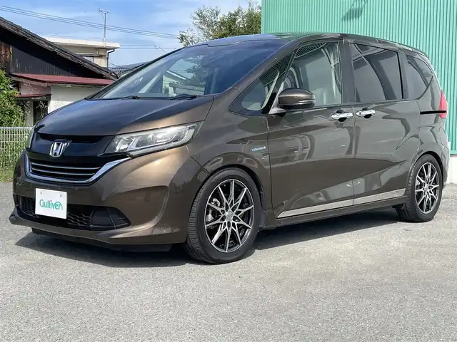 ホンダ フリード ハイブリット EX 福岡県 2016(平28)年 10.5万km マンダリンゴールドM プッシュスタートボタン/スマートキー/クルーズコントロール/Bluetoothオーディオ/ETC/フルセグTV/バックカメラ/ドライブレコーダー前後/運転席・助手席シートヒーター/両側パワースライドドア/社外アルミホイール（LEONIS）/純正フロアマット/LEDヘッドライト/自動ブレーキ